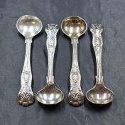 A set of four Victorian silver King's pattern salt spoons, having heraldic crests to the