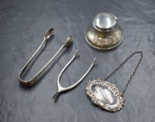 An early 20th century silver inkwell, of squat circular form having a hinged lid over a circular