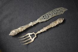 A Victorian silver fish fork and slice, having decorative pierced scroll work and embossed scroll