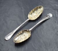 Two George II silver Hanoverian pattern berry spoons, having decorative engraving and vacant