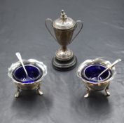 A cased pair of George V silver salts, having Chippendale style rims, moulding and 'h' initial to