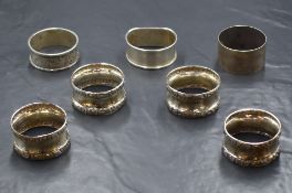 A group of four silver napkin rings, having decorative floral borders, marks for Birmingham 1902,
