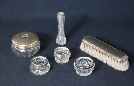 An assortment of silver mounted vanity wears, comprising a silver topped cut glass powder pot