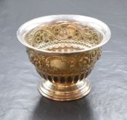 A Victorian silver pedestal bowl, having a flared rim with embossed floral scroll decoration and two