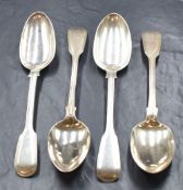 A group of four William IV and Victorian silver fiddle and thread pattern serving spoons, having