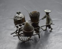 A Chinese novelty white metal three piece condiment set, comprising salt, pepper and mustard in