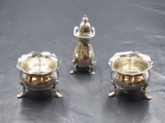 A pair of late Edwardian silver salts, of bulbous form having Chippendale style rims, raised three