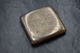 A George V silver cigarette case, of hinged rectangular form having decorative scroll engraving