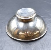 A George V silver inkwell, the large circular domed inkwell, having a hinged moulded cap and a