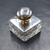 A George V silver mounted cut glass inkwell, of square form having a circular cap engraved 'B.P.',