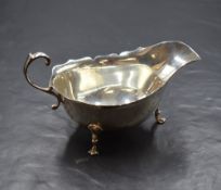 An Elizabeth II silver sauce boat, of traditional form having Chippendale style rim, wide spout