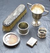 An assortment of silver and silver mounted items, comprising two napkin rings, a vesta case, a small