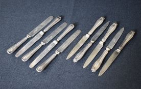 A group of five George V silver handled fruit knives, having decorative terminals, marks for