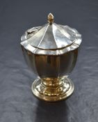 An Edwardian silver tea caddy, of circular form having a hinged lid and slight Chippendale style rim