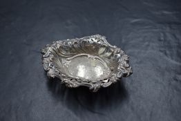 A Victorian silver dish, of oval form having a floral scroll rim and pierced walls, raised on a