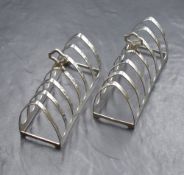 A pair of Elizabeth II silver toast racks, rectangular form with triangular divisions, raised on