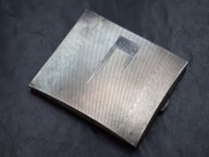 A George V silver cigarette case, of hinged rectangular form having engine turned decoration and