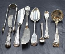 An assortment of 19th century flatware and cutlery, comprising King's pattern sugar sifter, fish