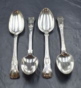 A group of four early 19th century silver King's pattern serving spoons, having heraldic crests to