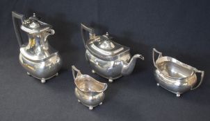 A George V silver four piece tea set, comprising coffee pot, teapot, sugar and cream, of oval