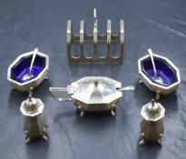 A George V silver five piece condiment set, comprising two salts, mustard and two pepperettes, of