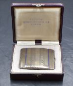 A cased white metal presumed silver cigarette case, of hinged rectangular form having engine
