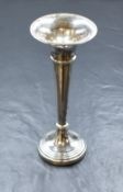 An Elizabeth II silver vase, of fluted form having a flared rim, raised on a circular step moulded