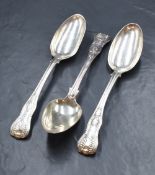 A group of three George IV silver King's patterns serving spoons, having dog heraldic crests to