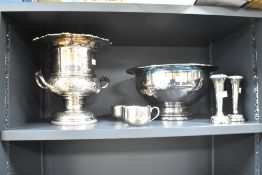 A silver plated urn decorated with floral patterns and raised on a circular footed base, h26cm, sold