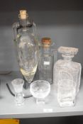 An Art Deco style decanter having cut glass geometric patterns, h22cm, sold together with 1 other