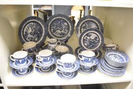 A Churchill ceramic dinner service decorated in the Willow pattern, to include bowls, cups and