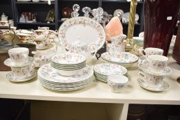 A Churchill dinner service decorated with floral patterns, to include plate, tea pot cups and