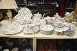 A Minton Haddon Hall dinner service, to include tea pot, clock, cups and saucers ect *Please note