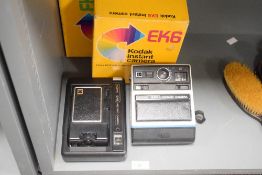 Two Kodak Instant cameras. An EK8 and an EK6