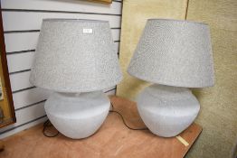 A pair of stone effect table lamps of lobed form, h60cm