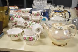 A Royal Vale bone china tea service having gilt edge and floral patterns, comprising of 9 cups, 7