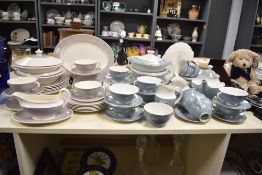 A Royal-Doulton fine bone china dinner service decorated with floral patterns on a duck egg