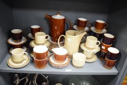Two Poole pottery tea services, to include tea pots, cups and saucers