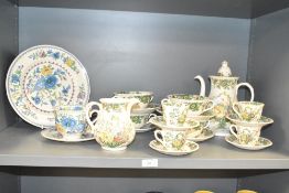 A Mason's ironstone 'Strathmore' pattern dinner service, decorated with floral patterns on a cream