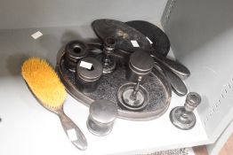 An ebony dressing table set, to include a pair of mirrors, brush and candlesticks ect, (11)