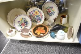 A vintage Poole pottery plate decorated in the LE pattern, w23cm, sold together with a Poole sauce