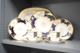 A Coalport part tea service having gilt edges and floral patterns, comprising of 2 cups, 2