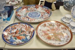 A large Imari porcelain charger decorated with floral and geometrical patterns, w46cm, sold together