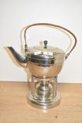 A metal kettle on stand having wicker handle, h37cm