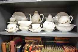 A fine porcelain tea service decorated with Chinese landscape scenes on a white ground, to include