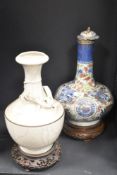 A Chinese vase of onion form raised on a carved wooden plinth, h37cm, sold together with 1 other