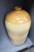 A large stoneware flagon having impressed marks for 'Rowland Atkinson Wine & Spirit Merchant