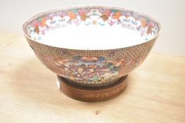 A large Chinese style bowl decorated with floral patterns and raised on a circular base, w29cm