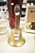 A vintage brass bell having wooden handle, h26cm