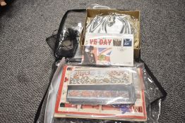 A bag containing various stamps and post cards, to include a VE-DAY coin ect
